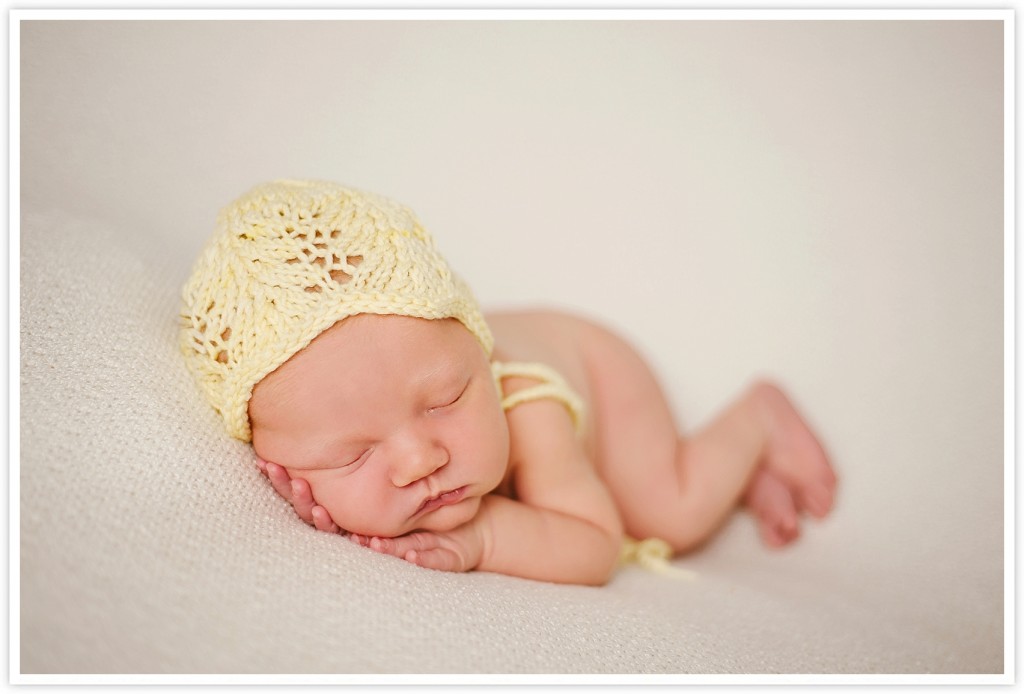 Newborn girl in a yellow hat