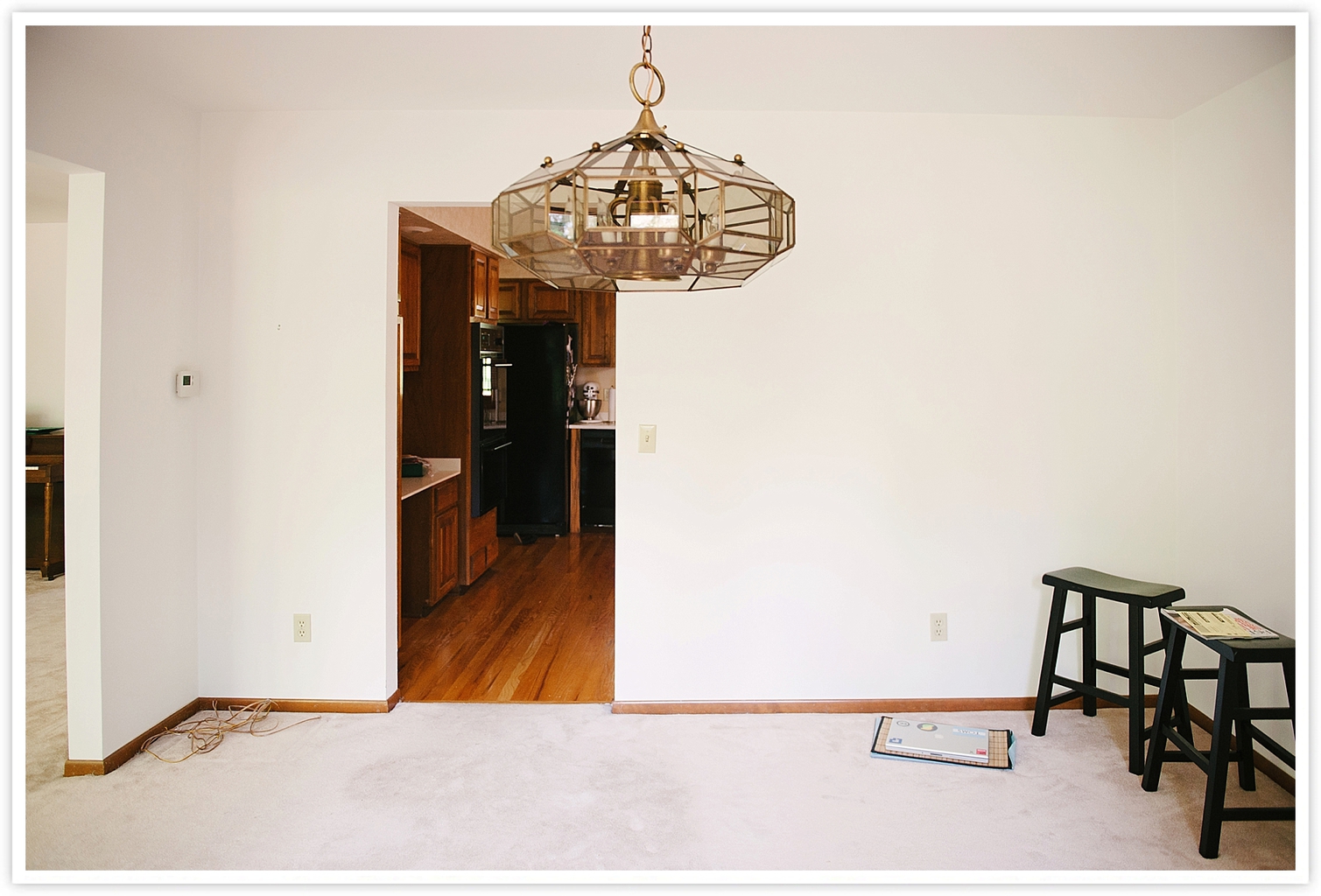 Before: dining room with carpet and hanging pendant light