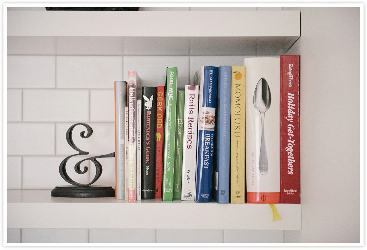 Open shelving books with ampersand bookend