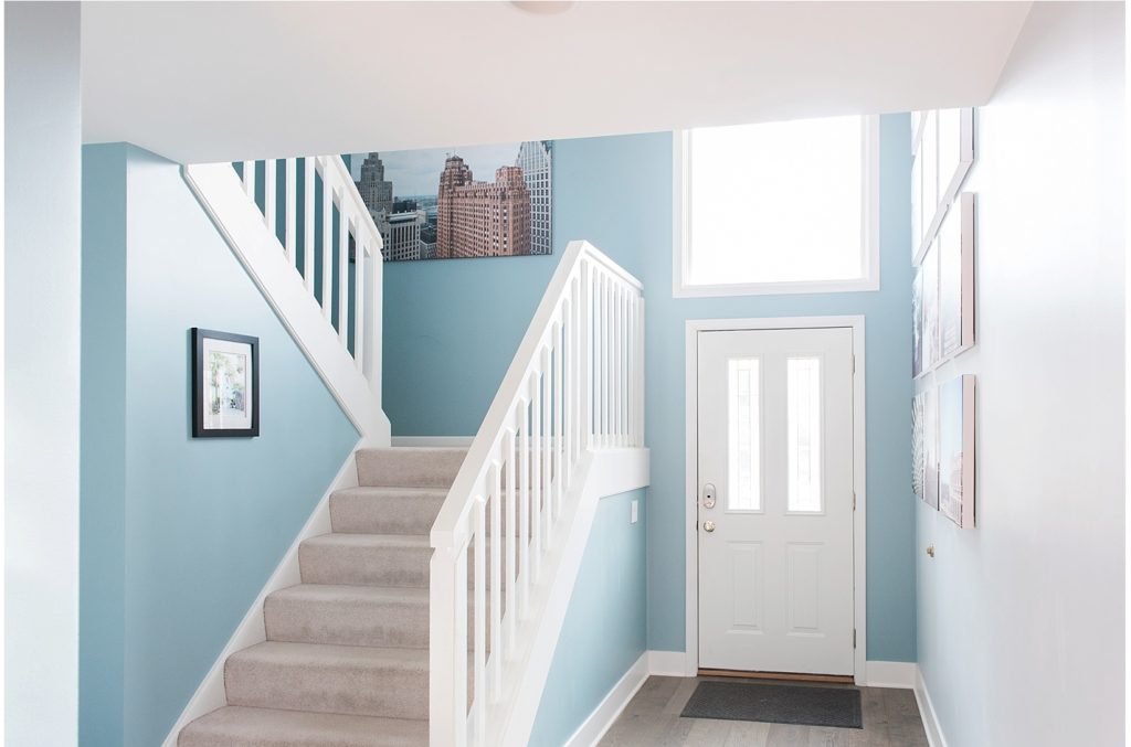 stairway with blue walls and canvas prints