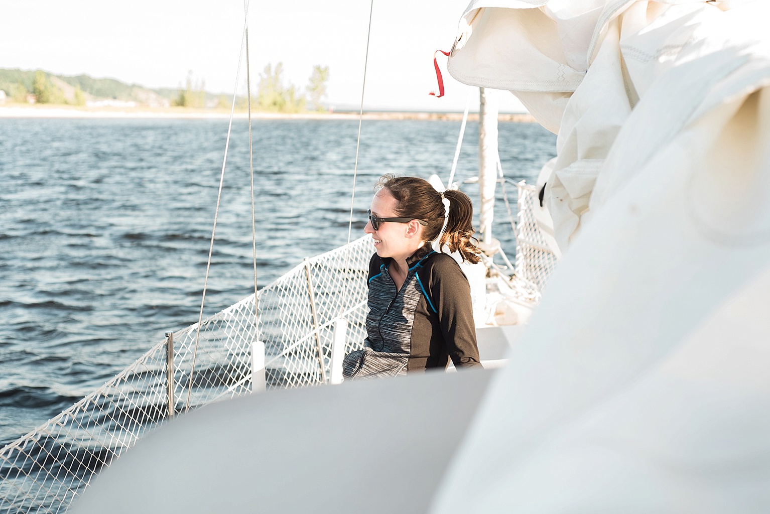 a photo of Allie Siarto sitting on the deck of a Catalina 30 sailboat