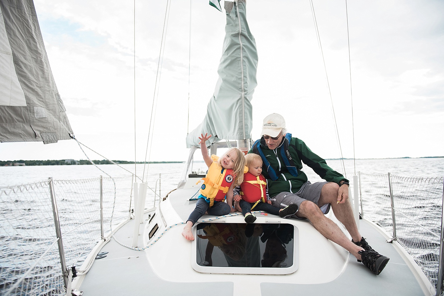 family sailing on a Catalina 30 on the deck