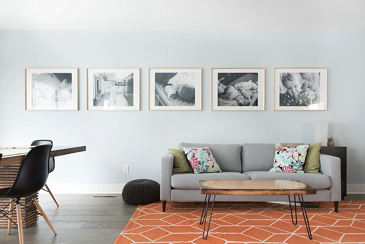 living room wall with large black and white framed photographs