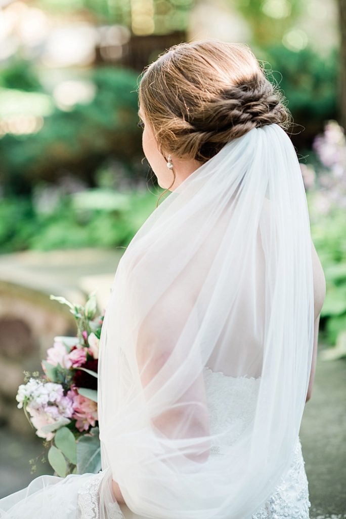 Bridal portraits with veil in the gardens of The English Inn, a Lansing wedding venue