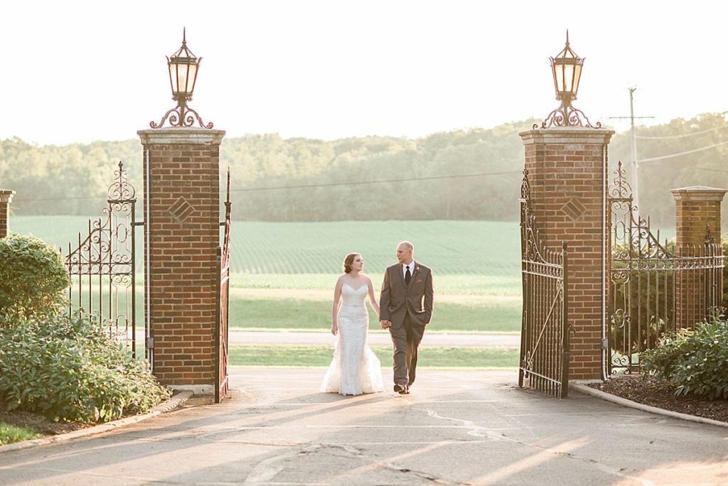 bride and groom photos by the front gate of The English Inn, by Allie & Co. Lansing wedding photography