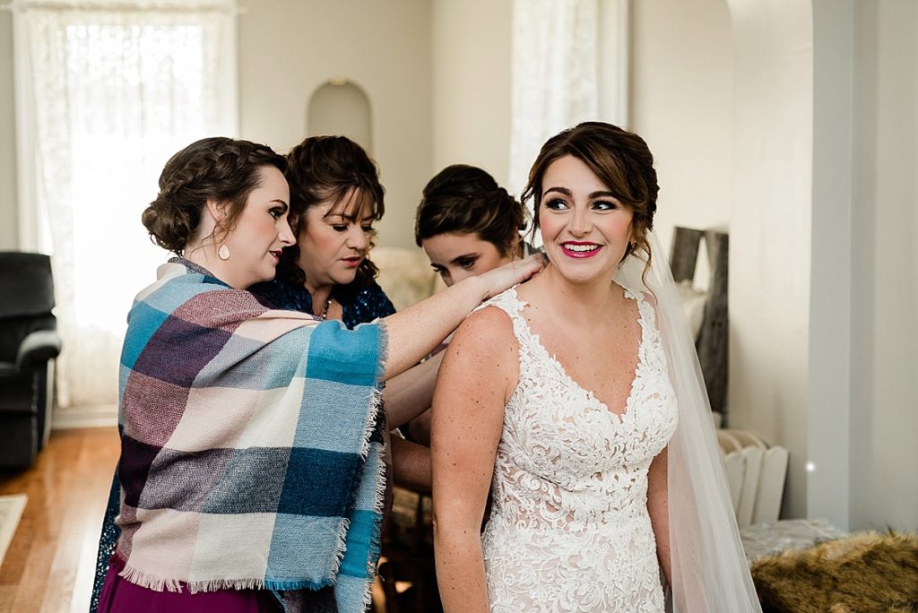 A photo of the bride getting ready in the farm house at Stone House Farm in Michigan