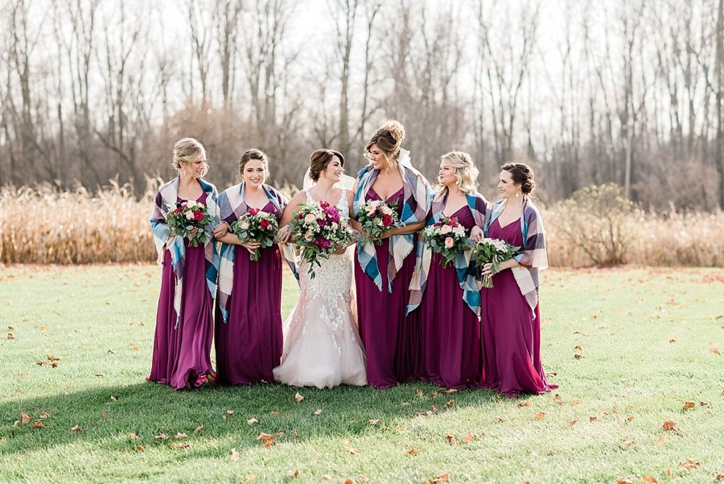 A photo of the bridesmaids during a late fall outdoor wedding at Stone House Farm, a Michigan barn wedding venue