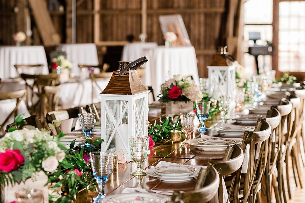 photos of the wedding reception room, including vintage china placesettings on a wooden table at Stone House Farm, a Michigan barn wedding venue, by Allie & Co. Photography, Michigan wedding photographers
