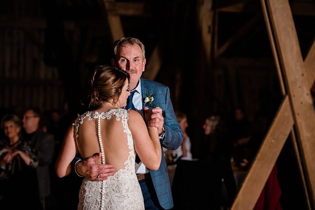 A photo of a bride dancing with her father at Stone House Farm, a Michigan barn wedding venue, by Allie & Co. Photography, Michigan wedding photographers
