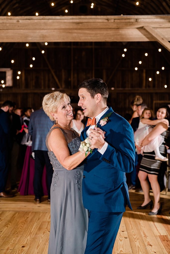A photo of the groom dancing with his mom at Stone House Farm, a Michigan barn wedding venue, by Allie & Co. Photography, Michigan wedding photographers