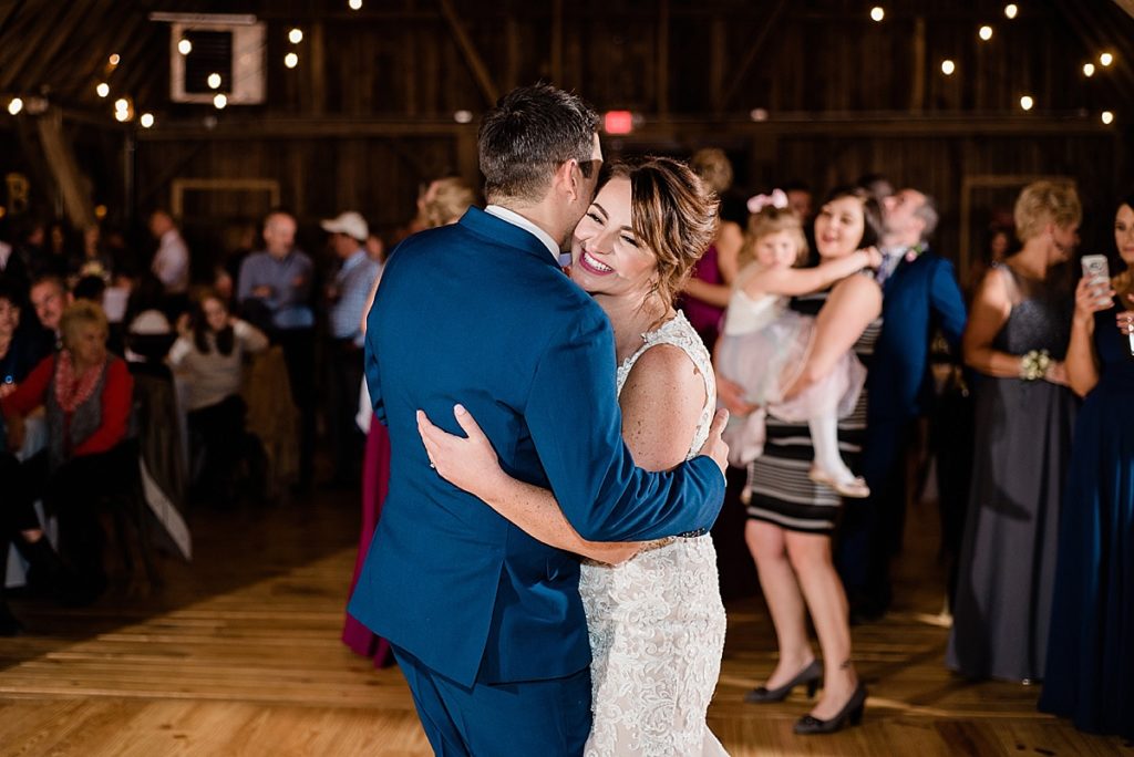 A photo of the bride and groom's first dance at Stone House Farm, a Michigan barn wedding venue, by Allie & Co. Photography, Michigan wedding photographers