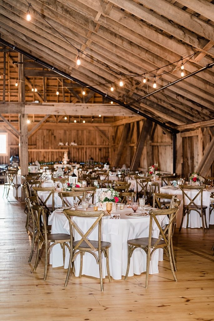 photos of the wedding reception room, including vintage china placesettings on a wooden table at Stone House Farm, a Michigan barn wedding venue, by Allie & Co. Photography, Michigan wedding photographers
