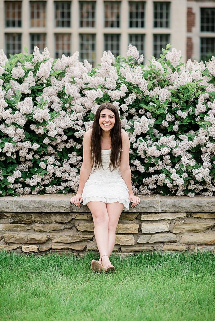 Michigan State University (MSU) senior photo in a white dress in front of Spring flowers East Lansing, Michigan - by Allie Siarto Photography, Michigan photographers