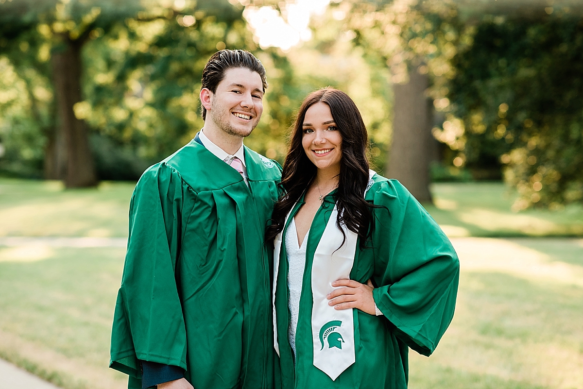 Michigan State Senior Pictures with a couple on MSU's campus in front of sunset and trees, by Allie Siarto & Co. Photography, MSU graduation photographers