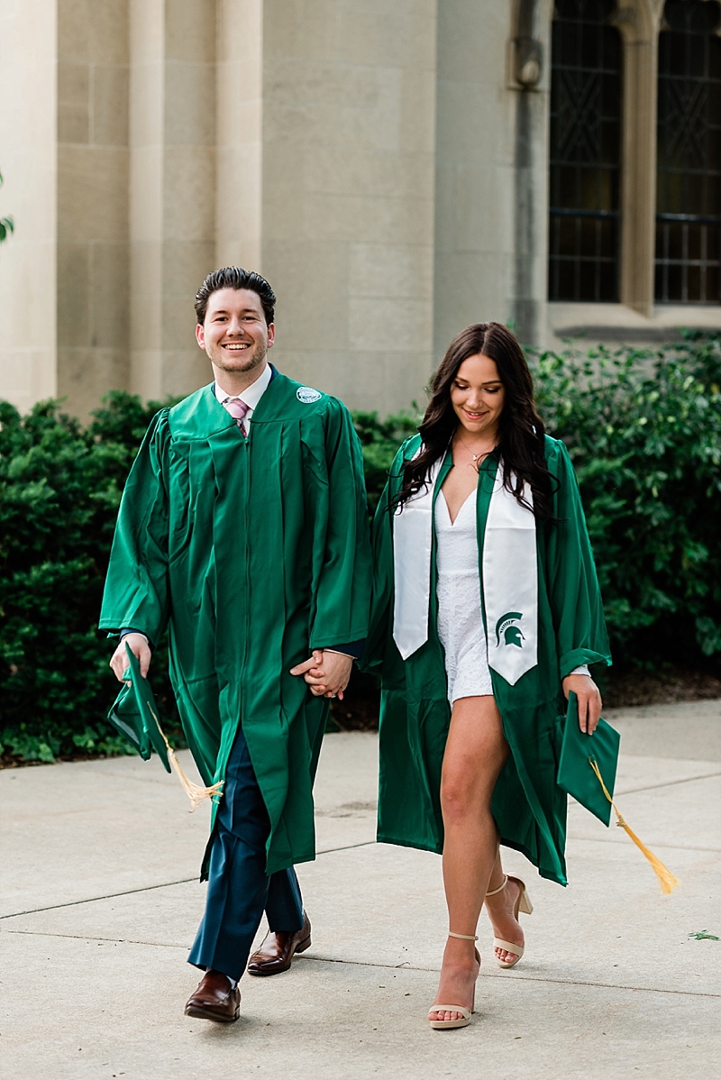 Michigan State Senior Pictures with a couple in cap and gown on MSU's campus by Beaumont Tower, by Allie Siarto & Co. Photography, MSU graduation photographers