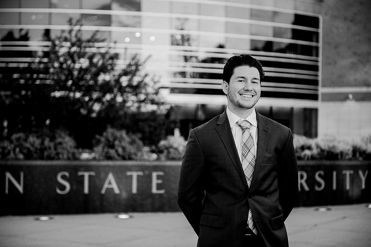 Michigan State Senior Pictures with a guy in a suit on MSU's campus in front of the Clara Bell Smith Center, by Allie Siarto & Co. Photography, MSU graduation photographers