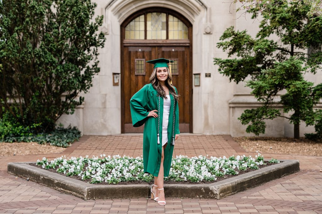 Michigan State University senior photography ideas with roommates on campus in white dresses and cap and gown in front of the door at Beaumont Tower, by Allie Siarto & Co, senior photographers in East Lansing, Michigan
