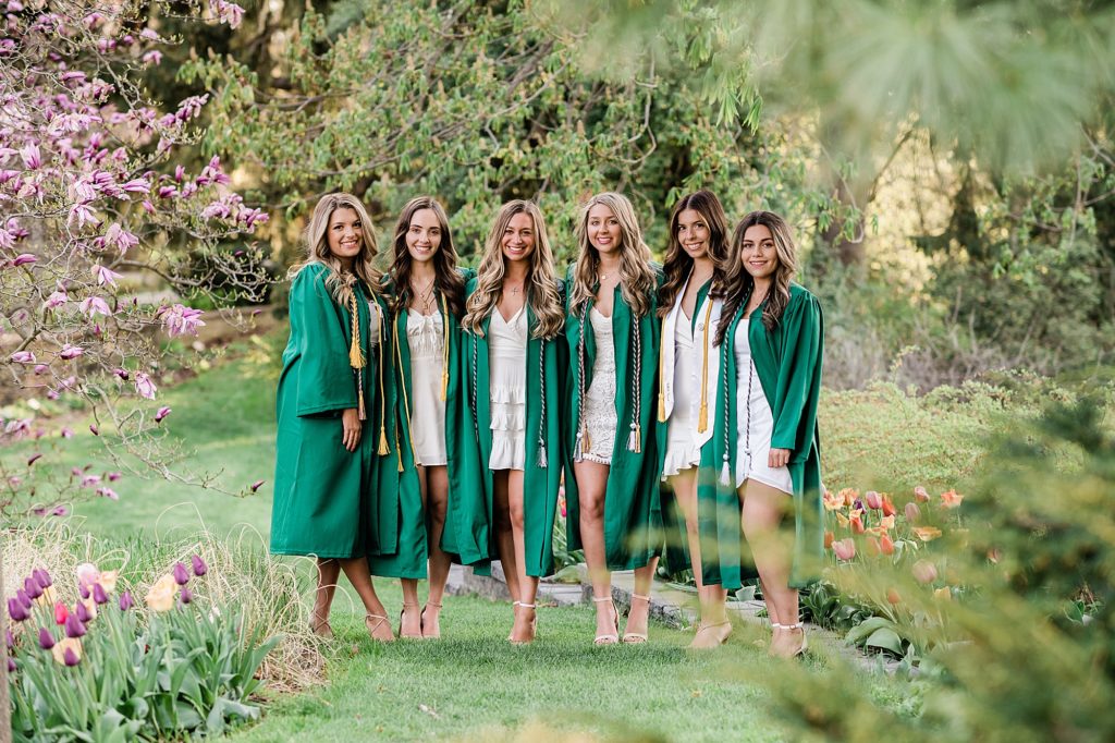Michigan State University senior photography ideas with roommates on campus in white dresses and cap and gown at the MSU Beal Gardens, by Allie Siarto & Co, senior photographers in East Lansing, Michigan