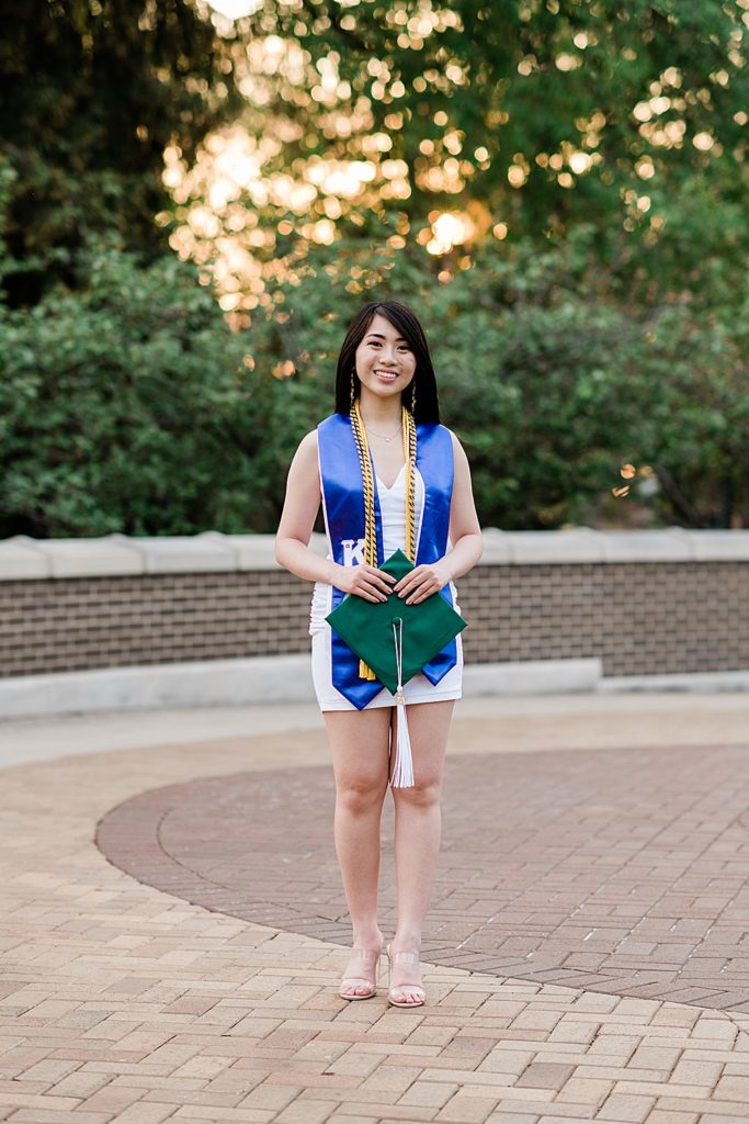 Michigan State Senior Graduation Pictures in cords and sash on campus; grad photos on the bridge over the Red Cedar River with Spartan Stadium in the background by Allie Siarto & Co. Photography