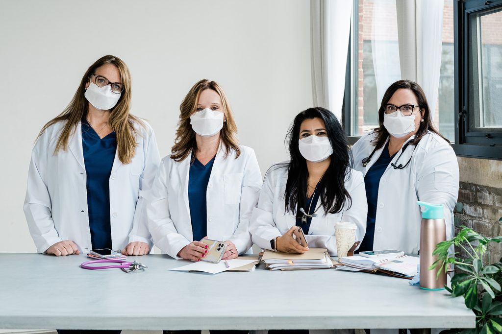 Studio branding headshots with four nurses wearing masks by Allie & Co. Photography in Lansing, Michigan