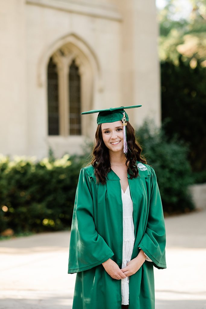 MSU graduation pictures on north campus in the fall with a white dress, cap, and grad gown with Beaumont Tower in the background by Allie & Co. Photography, East Lansing photographers
