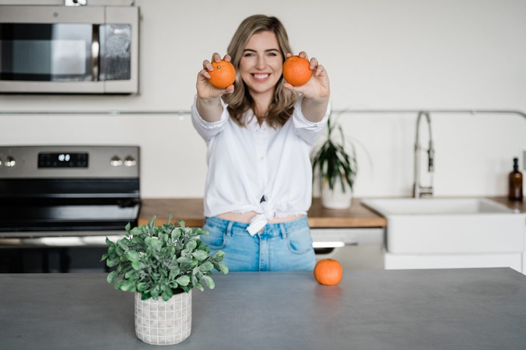 nutritionist branding photos in a kitchen with oranges at the Lansing Studio by Allie Siarto & Co. Photography, Lansing commercial photographers