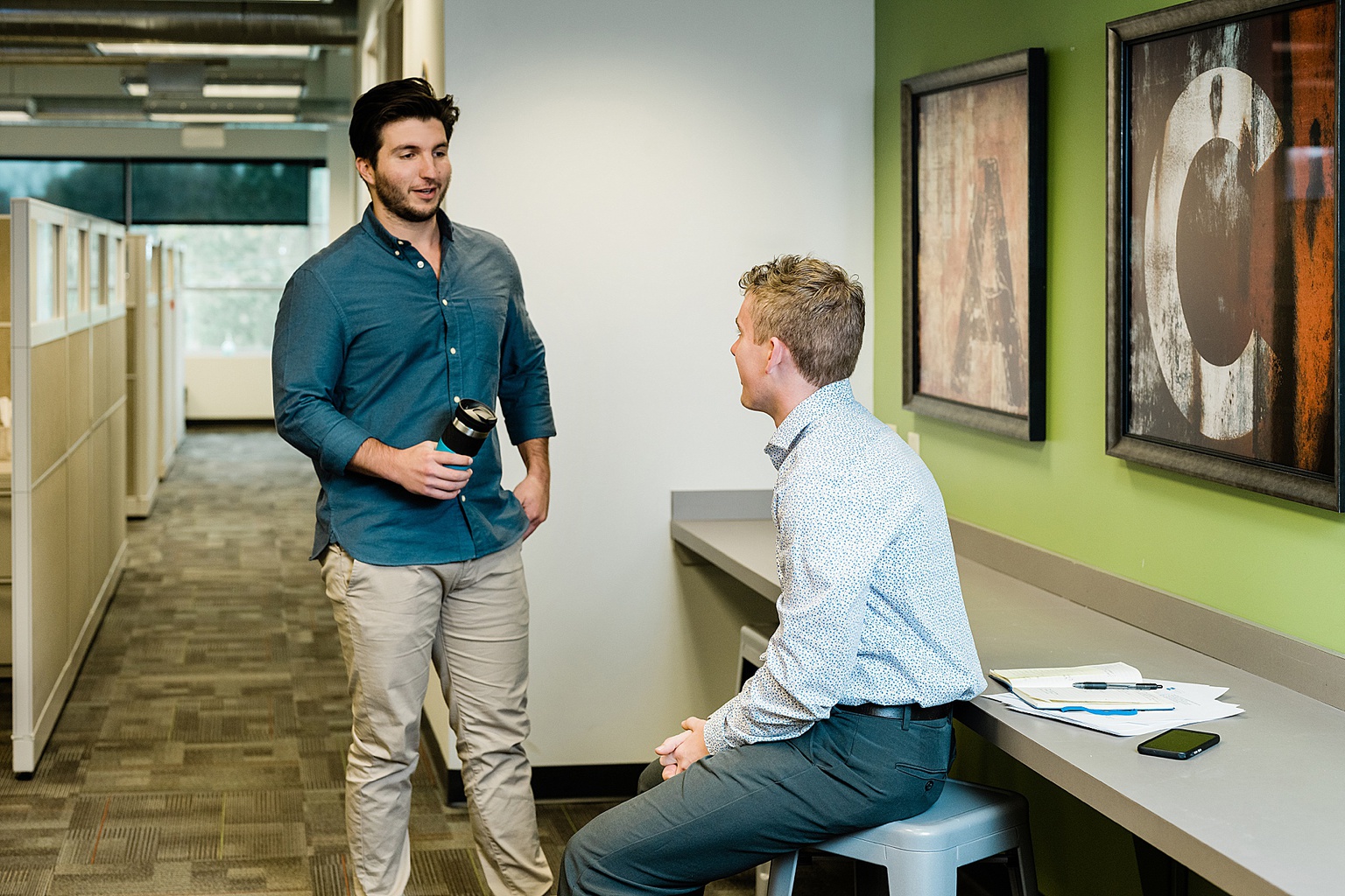 Lansing commercial photography - photo of two men talking in an office, by Allie Siarto & Co., Lansing branding and commercial photographer 