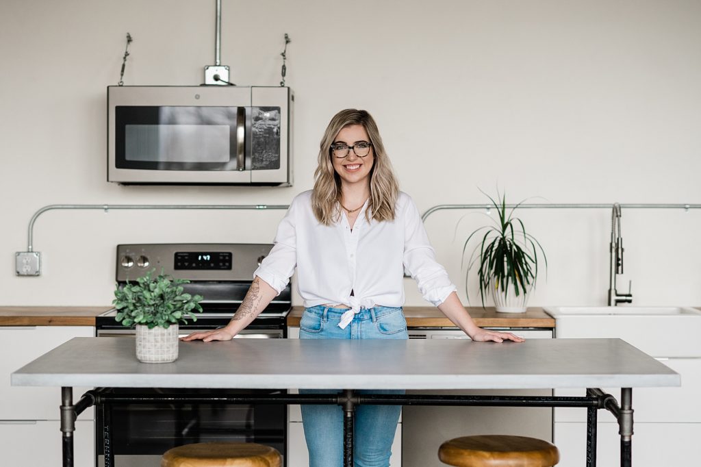 Lansing headshot photographer, photo of a nutritionist standing at a concrete table in a modern kitchen, by Allie Siarto & Co. Photography, Michigan branding photographers