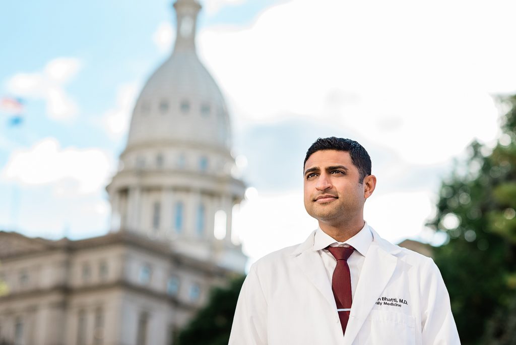 Lansing head shot photographer, close up photo of a doctor standing in front of the Lansing, Michigan Capital Building by Allie Siarto & Co. Photography, Michigan branding photographers