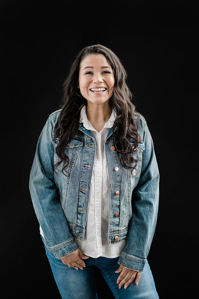 Lansing head shot photographer, photo of a woman in a jean jacket on a black backdrop, by Allie Siarto & Co. Photography, Michigan branding photographers