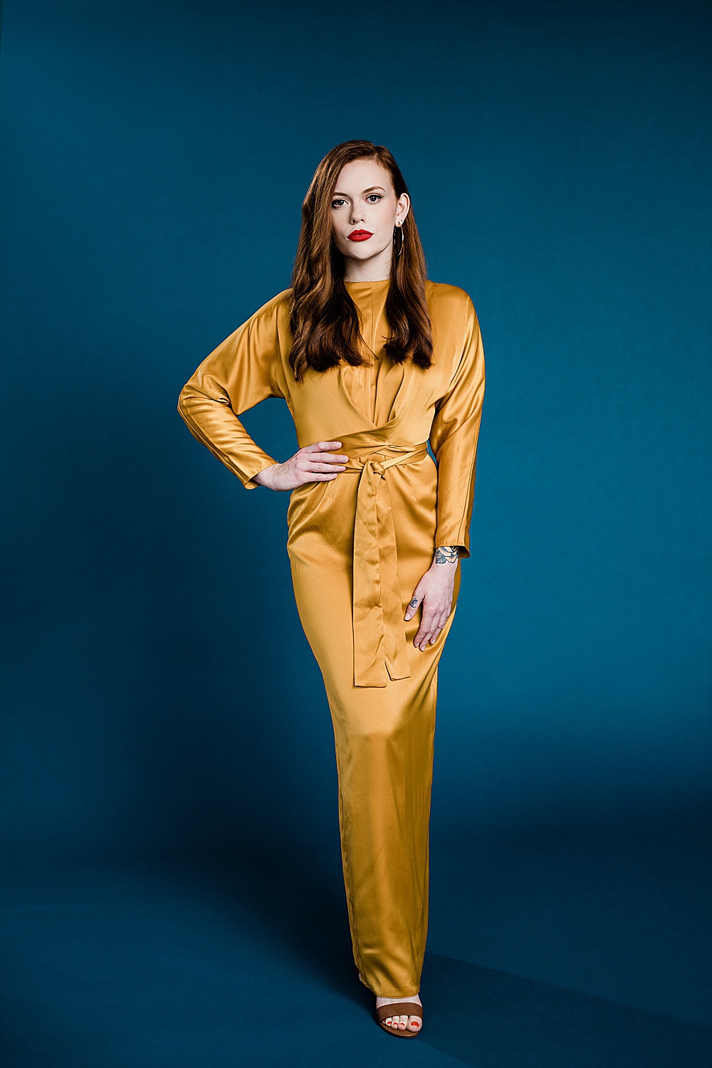 Lansing, Michigan commercial fashion photography, photo of a model in a yellow dress on a seamless blue backdrop by Allie Siarto & Co., Lansing commercial photographer
