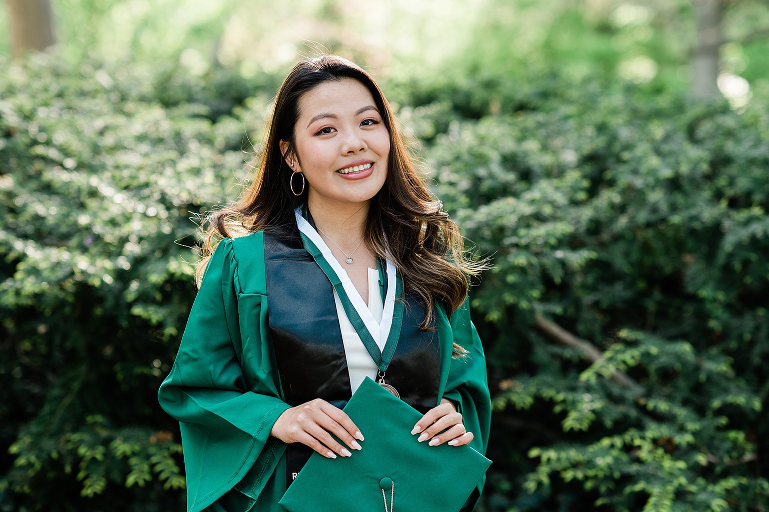 Michigan State Senior grad photoshoot on MSU's campus, close up photo of a woman in her graduation cap and gown, by Allie Siarto & Co., East Lansing photographers