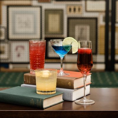 Photo of mixed drinks sitting on top of books at Graduate Hotel, East Lansing by Allie Siarto & Co. Lansing food photographer