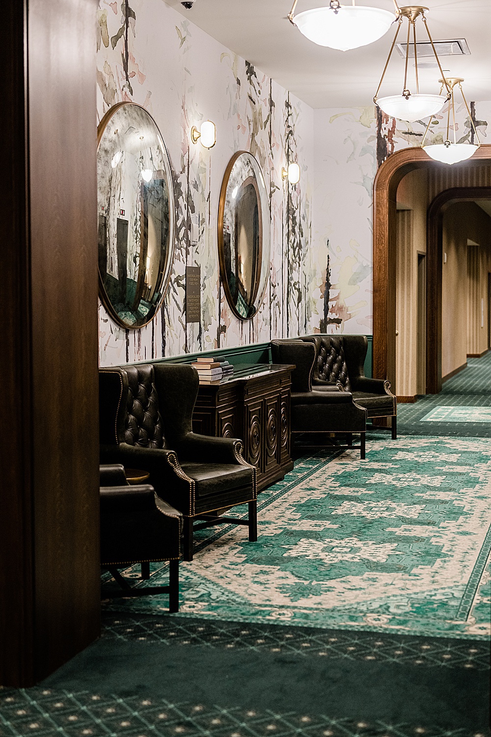 East Lansing's Graduate Hotel School Spirits Dinner, photo the hallway with leather chairs at Graduate Hotel, by Allie Siarto & Co. Photography, Lansing commercial photographer