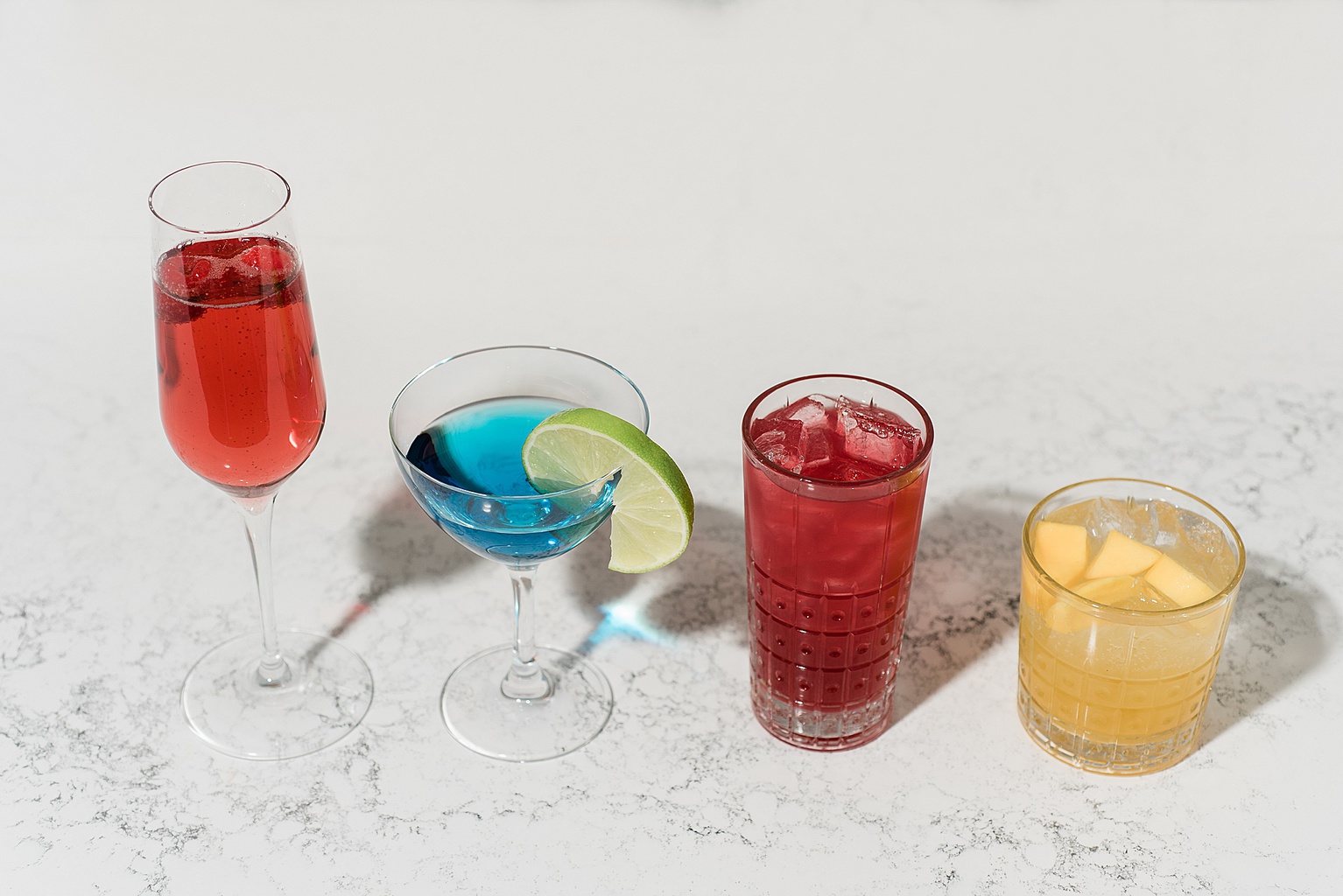 East Lansing's Graduate Hotel School Spirits Dinner, photo of mixed drinks lined up on a marble surface, by Allie Siarto & Co. Photography, Lansing commercial photographer
