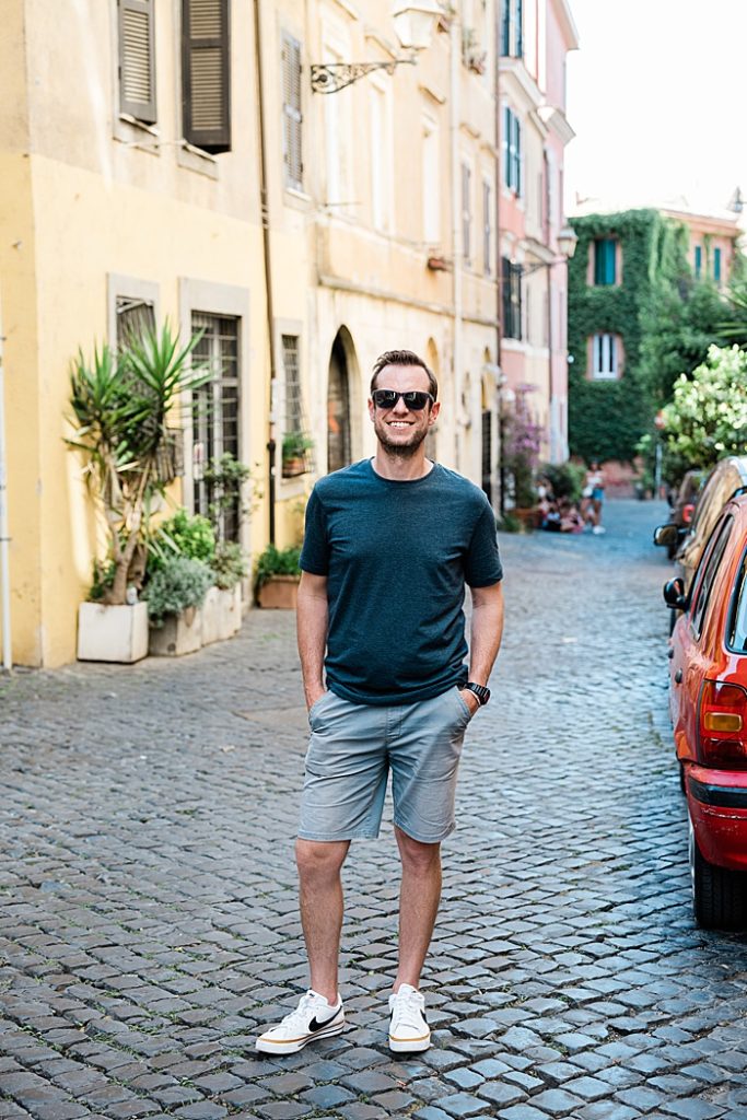 Michigan branding photographer in Rome - Jeff on a cobblestone street in Trastevere with a yellow building behind