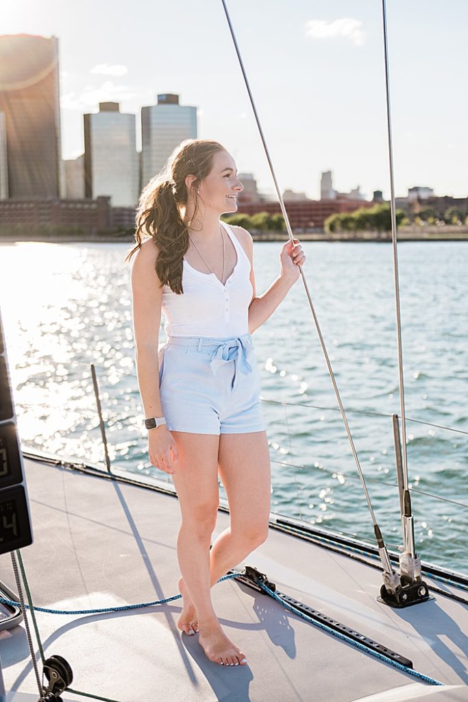 Detroit, Michigan headshot branding photos of a young photographer standing on a sailboat and looking out at the Detroit River - by Allie Siarto & Co. Photography, Michigan commercial and editorial photographers