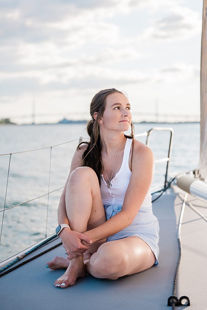 Detroit, Michigan headshot branding photos of a young photographer sitting on a sailboat and looking out at the Detroit River - by Allie Siarto & Co. Photography, Michigan commercial and editorial photographers