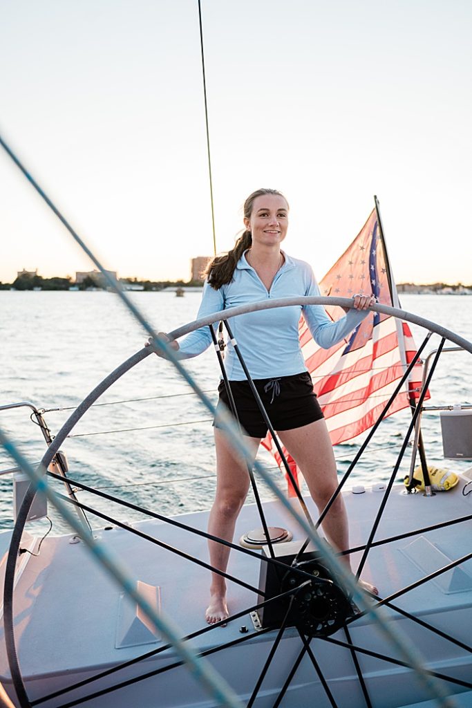 Detroit, Michigan headshot branding photos of a young photographer driving a 70 foot sailboat and smiling, surrounded by the Detroit River - by Allie Siarto & Co. Photography, Michigan commercial and editorial photographers