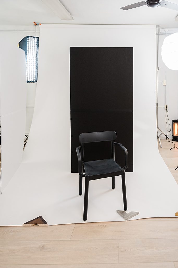A photo of a studio setup with a white seamless backdrop and black backdrop in downtown East Lansing, Michigan branding, product, and headshot photo studio, Allie Siarto Photography