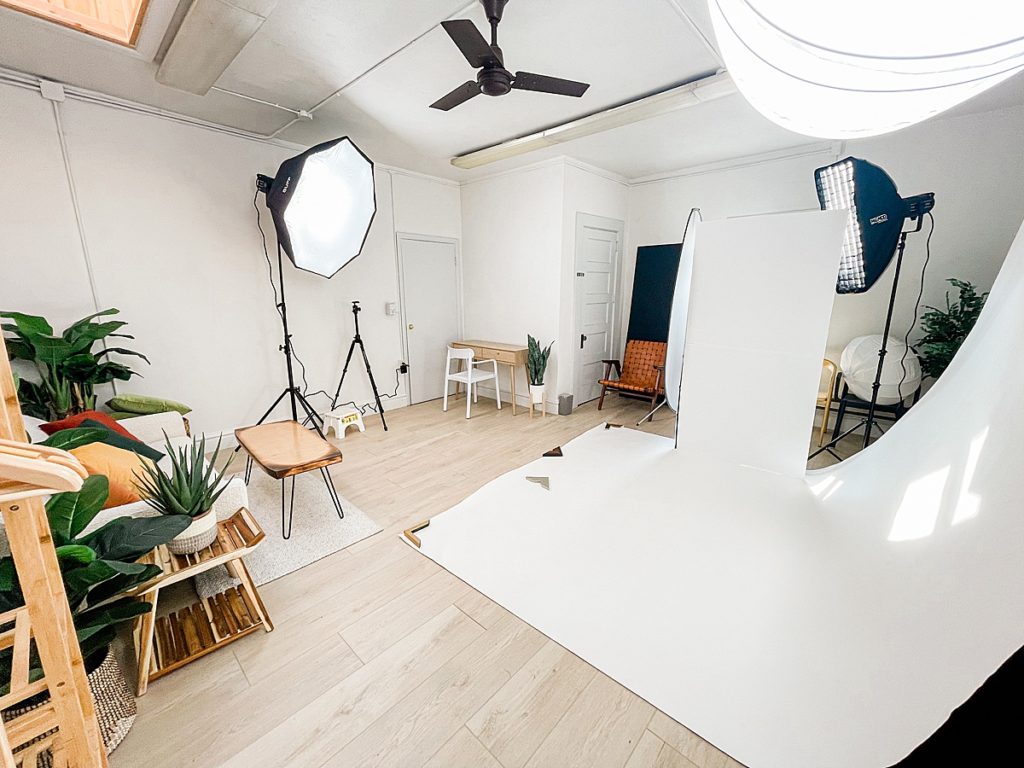A photo of a studio setup with a white seamless backdrop in downtown East Lansing, Michigan branding, product, and headshot photo studio, Allie Siarto Photography