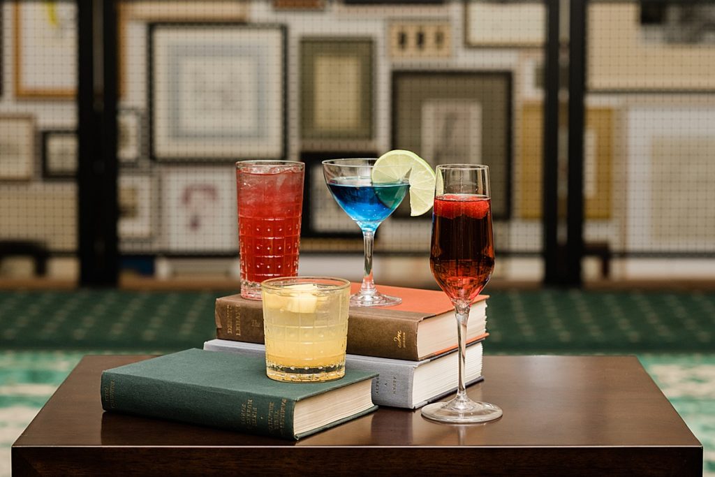 Product photo of four alcoholic beverages sitting on books at Graduate Hotel by Allie Siarto Photography, East Lansing, Michigan product photographers