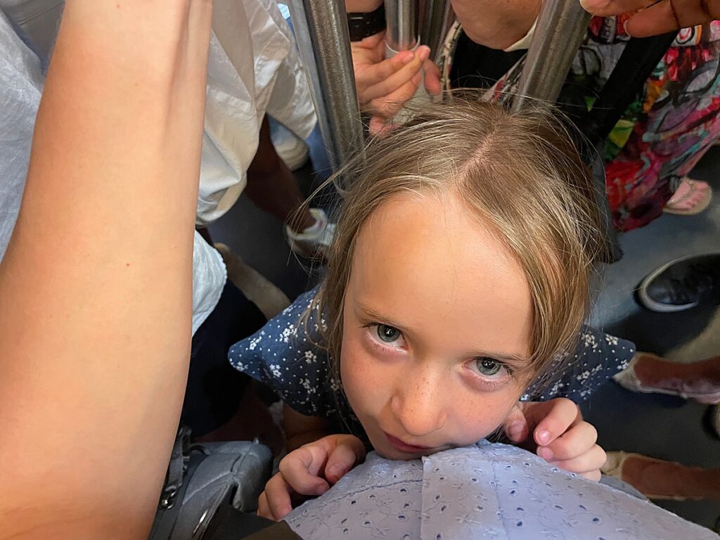 A crowded metro car in Paris, France with kids