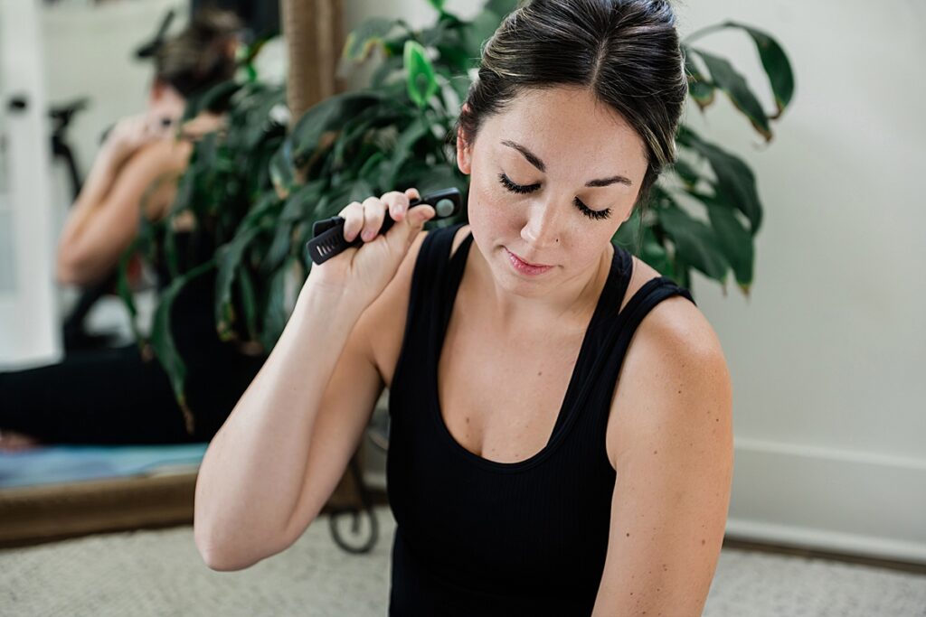 Product photography of a woman using the massage feature of an Ease Band. Photo by Allie Siarto, Lansing, Michigan product photographer.