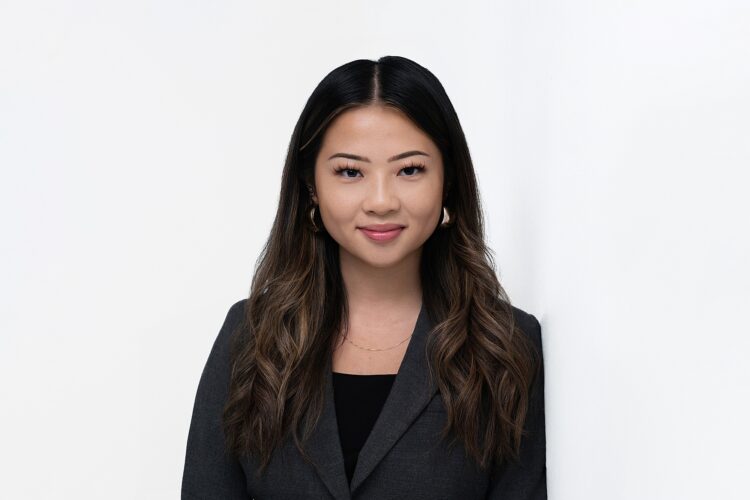 Sample headshot photo in the East Lansing, Michigan headshot photography studio - a woman leaning against a white wall